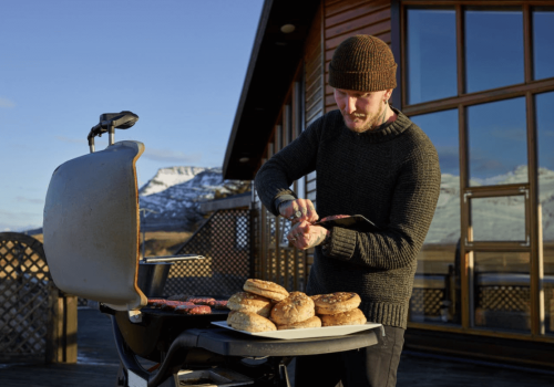 man preparing to grill the burgers